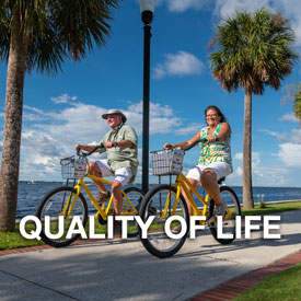 Punta Gorda Quality of Life button - couple on bikes by waterfront
