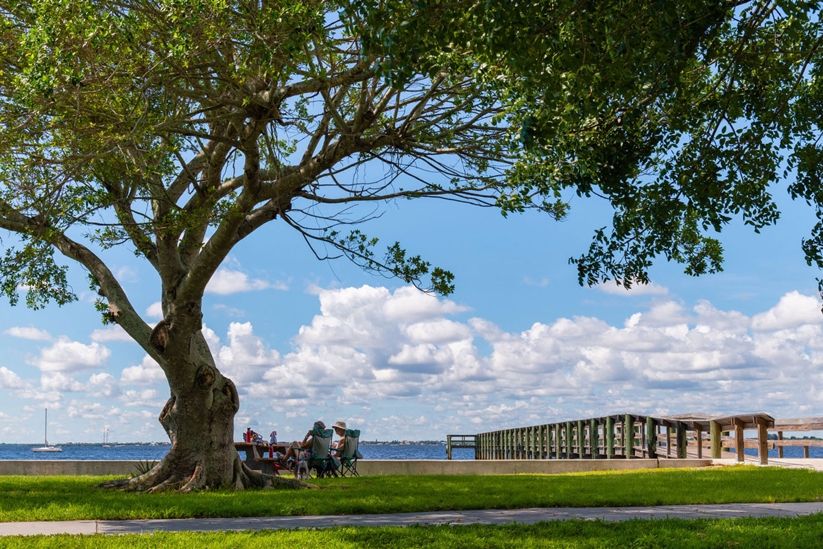 Punta Gorda people sitting by waterfront and pier